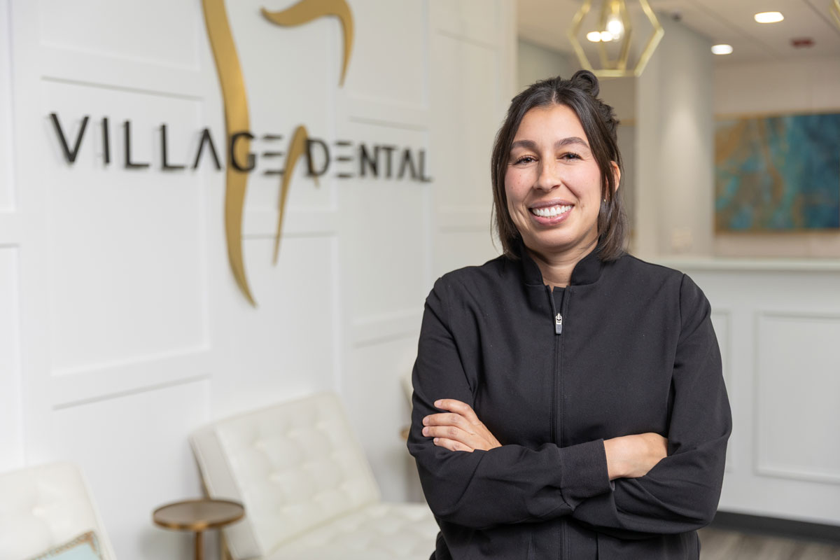 Smiling dental professional at Village Dental in Village, CO with crossed arms