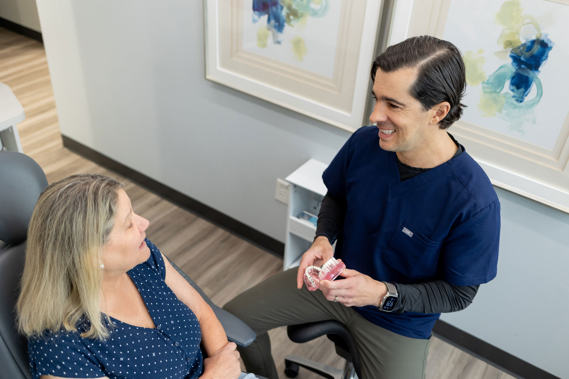 Dentist explaining dental model to patient at Village Dental in Village, CO