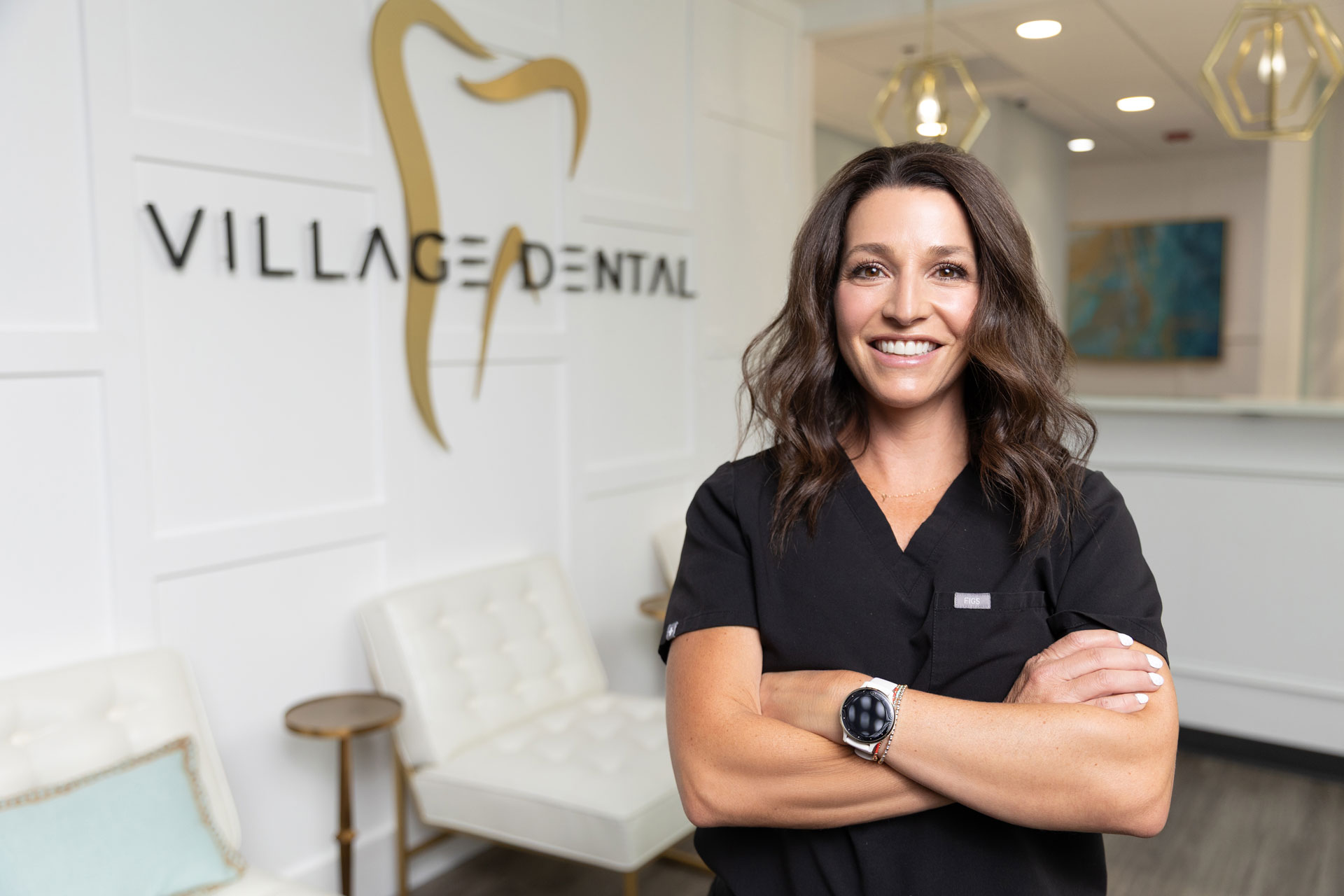 Confident dental professional posing at Village Dental in Village, CO office